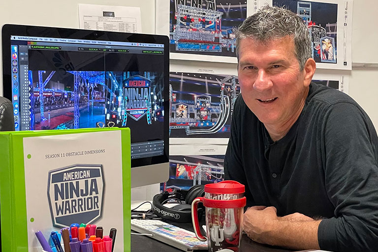 Brian Richardson posing with American Ninja Warrior materials.