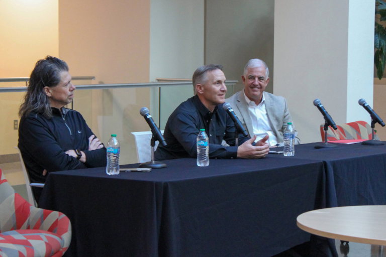 Three people speak at a panel.