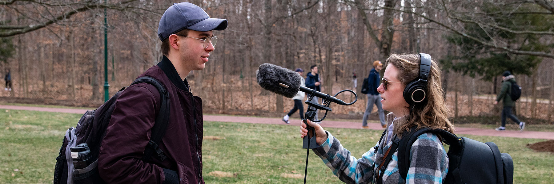 Emily Miles interviews Chris Forrester with a microphone.